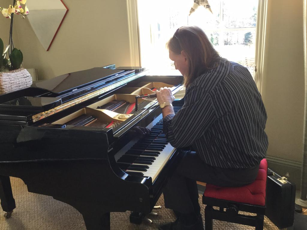 Mark the piano tuner working on a Spinnet Piano